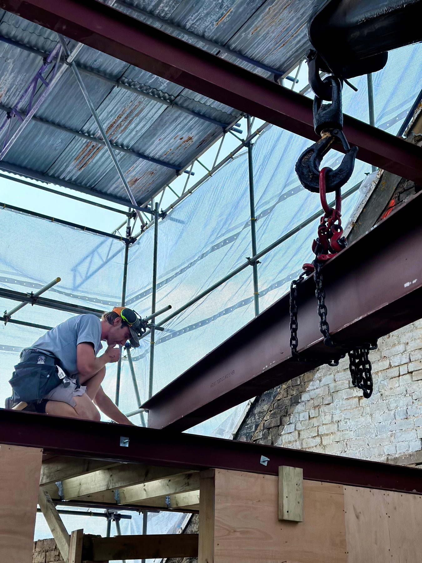 Setting a steel roof beam on site