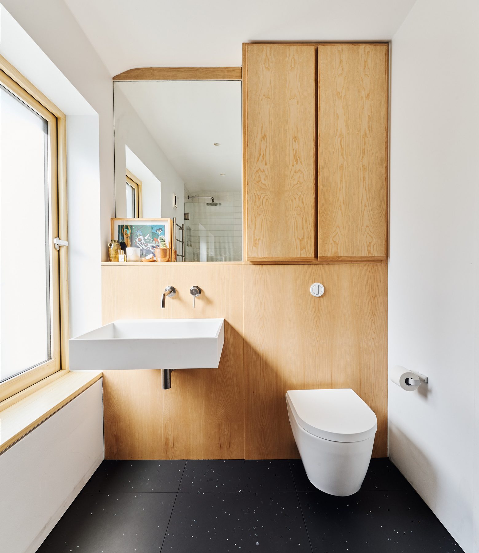 Bathroom lined in plywood with white fittings