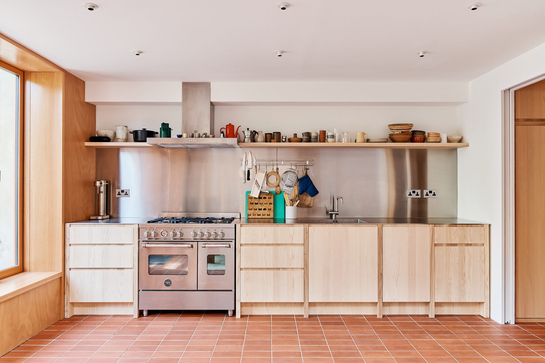 Kitchen with stainless steel and plywood cabinets