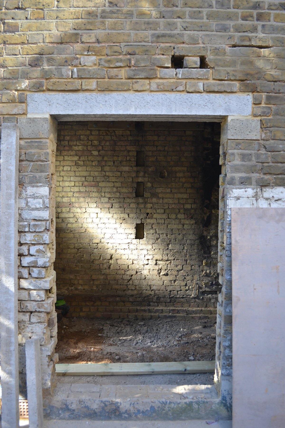 New structural opening formed in brickwork with a stone lintel