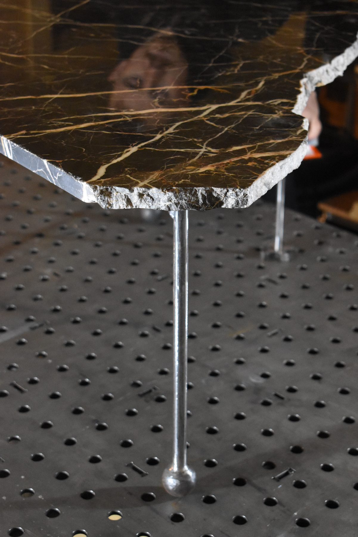 Marble offcut table on slender steel legs